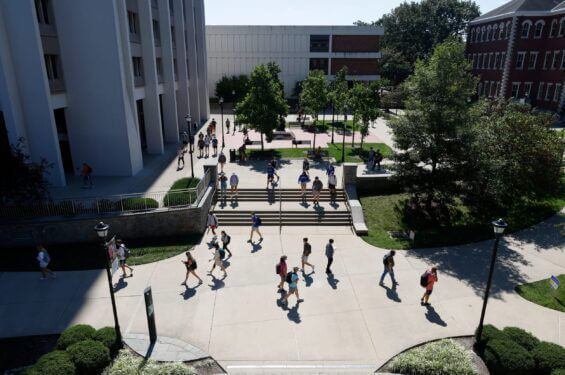 An aerial of a bustilng college courtyard at daytime.