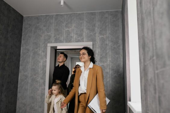 A young couple walks through an empty apartment during a showing.