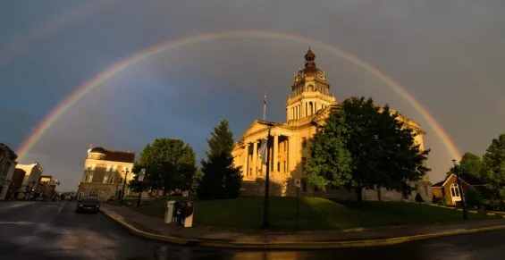 A double rainbow arches over a historic building in Bourbon County as the sun comes out after rain.